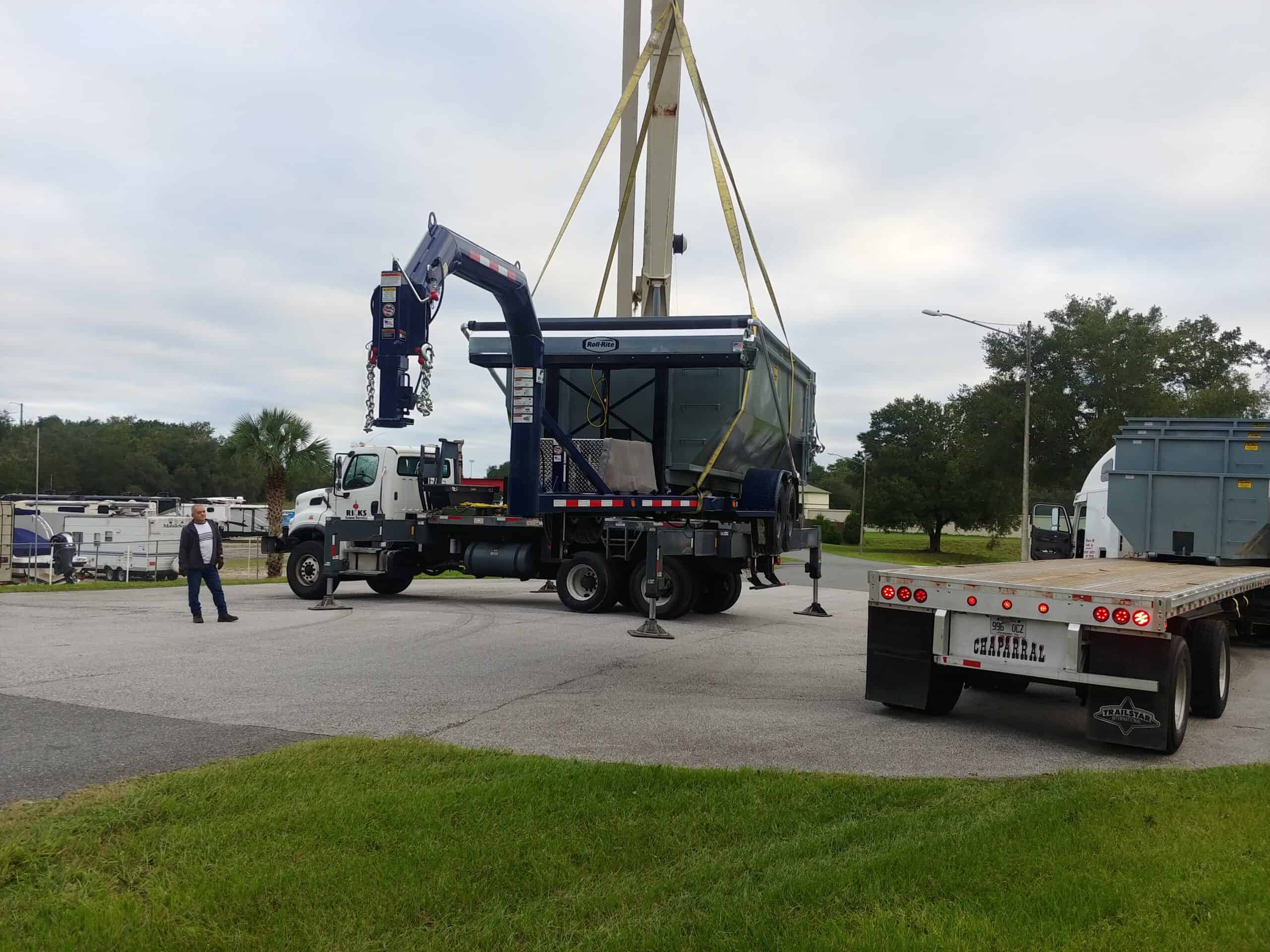 A dumpster by Yankee Dumpsters being lowered for a client in Ocoee, FL